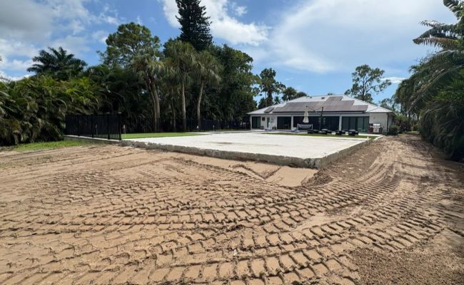 Large graded and compacted base pad prepped for a sport court or patio in a backyard in Southwest Florida