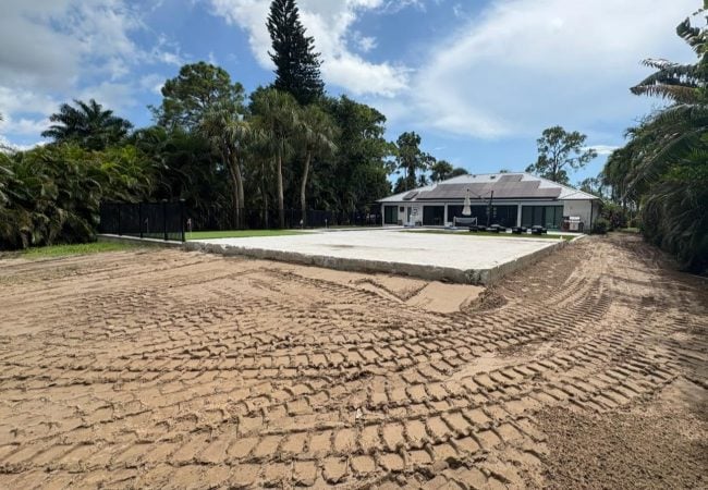 Large graded and compacted base pad prepped for a sport court or patio in a backyard in Southwest Florida