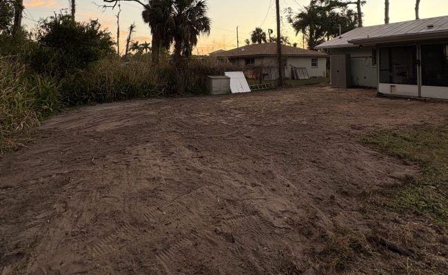 Cleared and graded residential backyard at sunset, ready for the next phase, in Southwest Florida